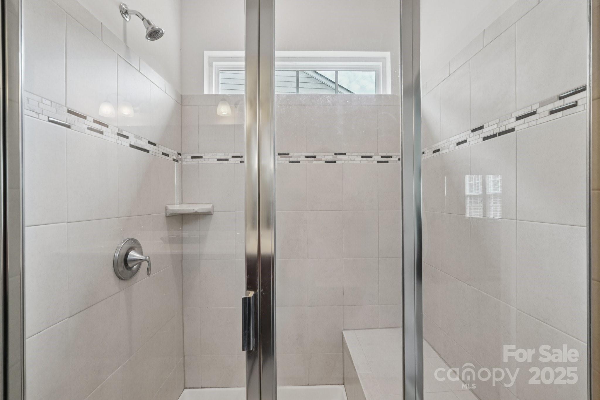 8058 Asher Chase Trail Lancaster, SC 29720 - Photo 19 of 48 a bathroom with a glass shower door