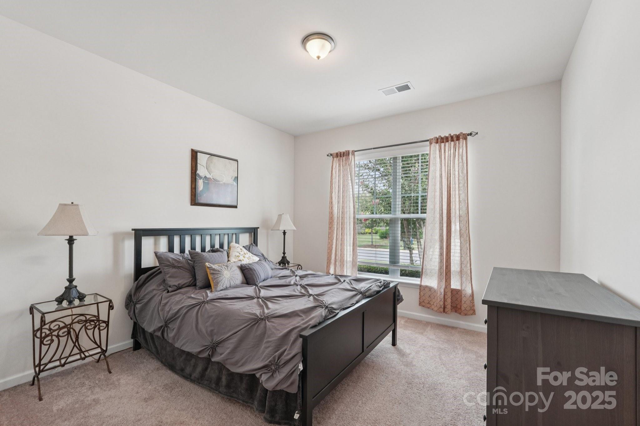 8058 Asher Chase Trail Lancaster, SC 29720 - Photo 24 of 48 a bed sitting in a bedroom next to a window