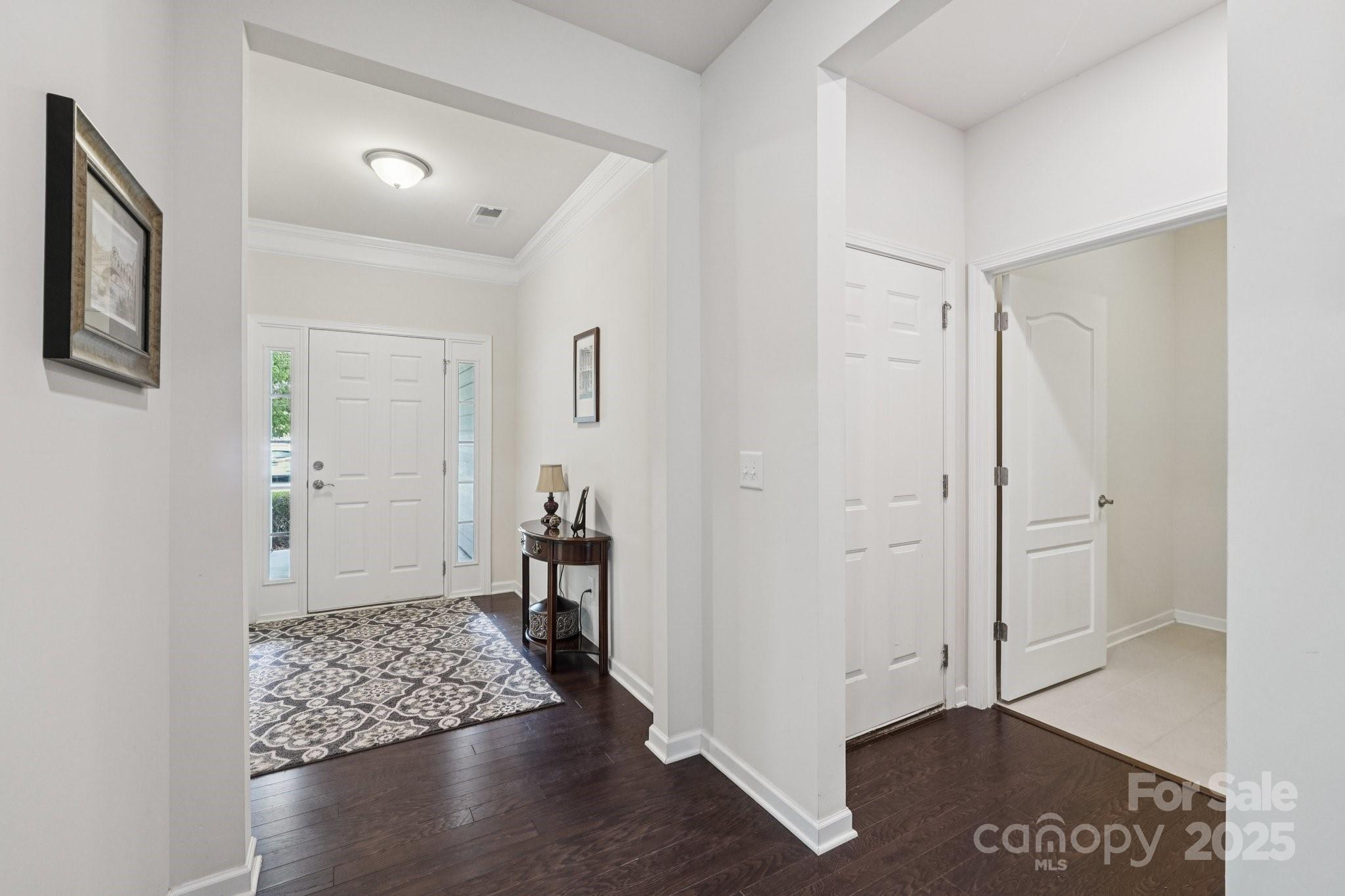 8058 Asher Chase Trail Lancaster, SC 29720 - Photo 3 of 48 a view of a hallway with wooden floor and a bathroom