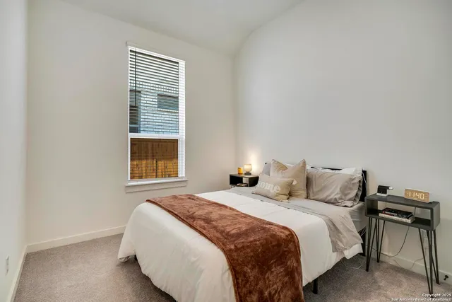 a bedroom with a bed and a window