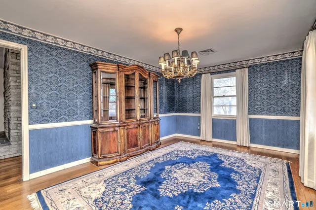 a view of a livingroom with furniture wooden floor and a rug