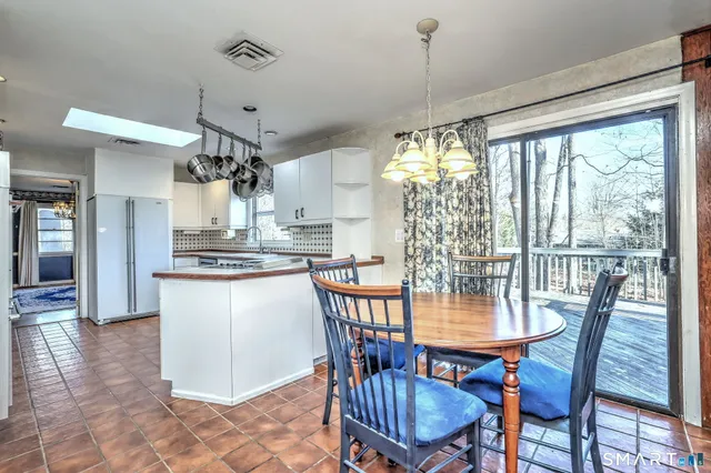 a view of a dining room with furniture a chandelier and wooden floor