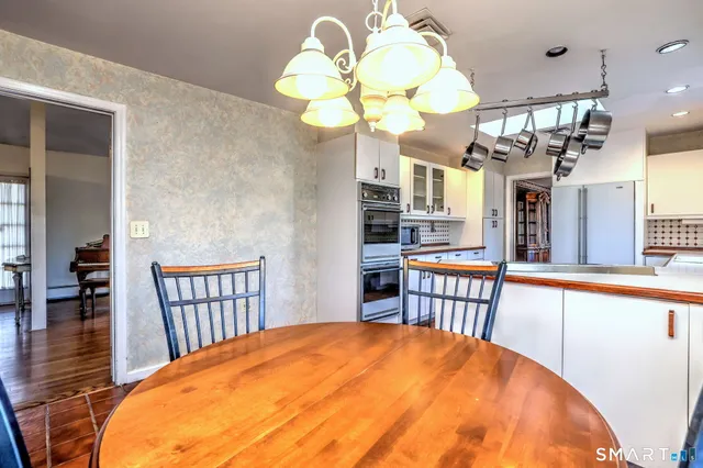 a large kitchen with stainless steel appliances granite countertop a sink and cabinets