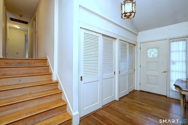a bedroom with a bed and dresser with mirror