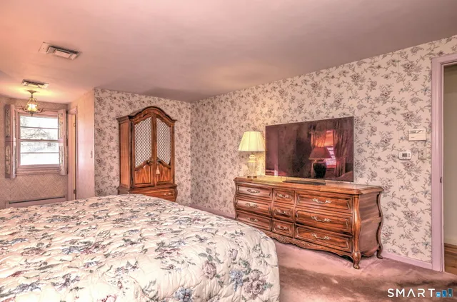 a bedroom with a bed and a dresser