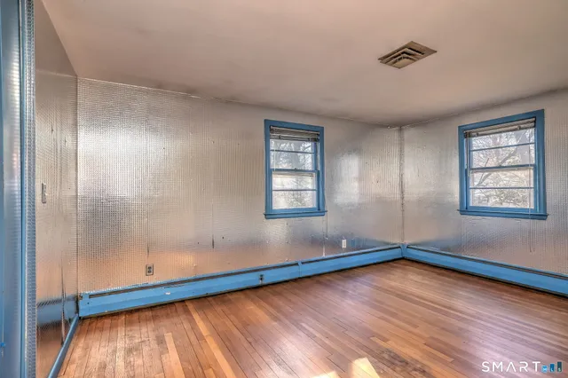 a bathroom with a sink a toilet and a window