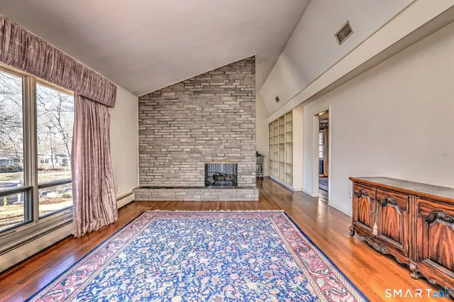 a living room with furniture rug and a fireplace