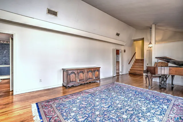 a view of a hallway view with wooden floor and staircase