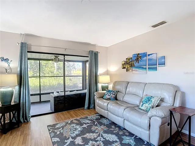 a bedroom with a bed and a dresser next to a window