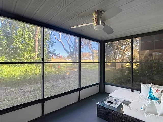 a bedroom with a bed and a lamp next to a window with outer view