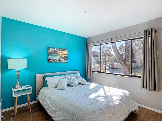 a bedroom with a large bed and a large window