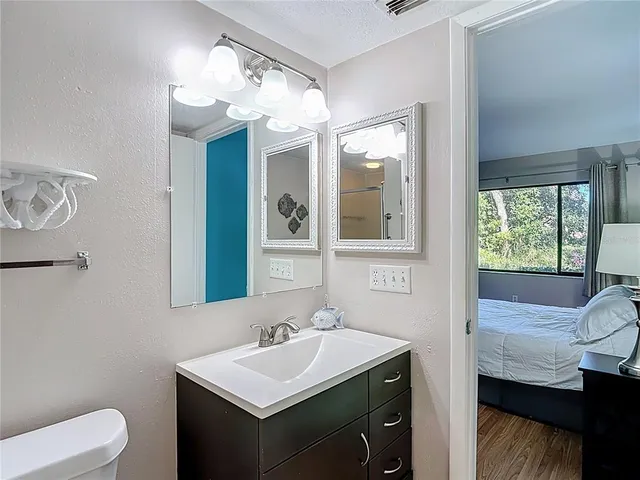 a bathroom with a toilet sink and mirror
