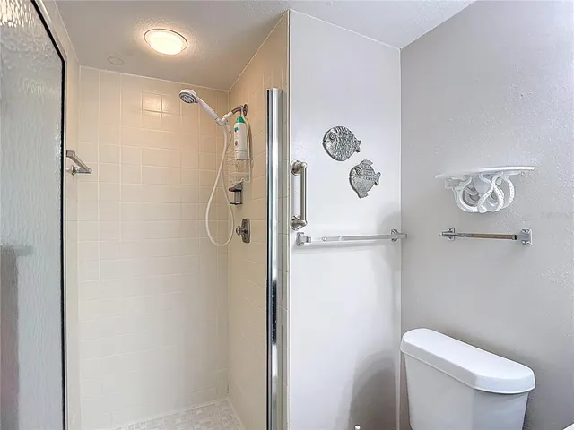 a kitchen with stainless steel appliances granite countertop white cabinets and refrigerator