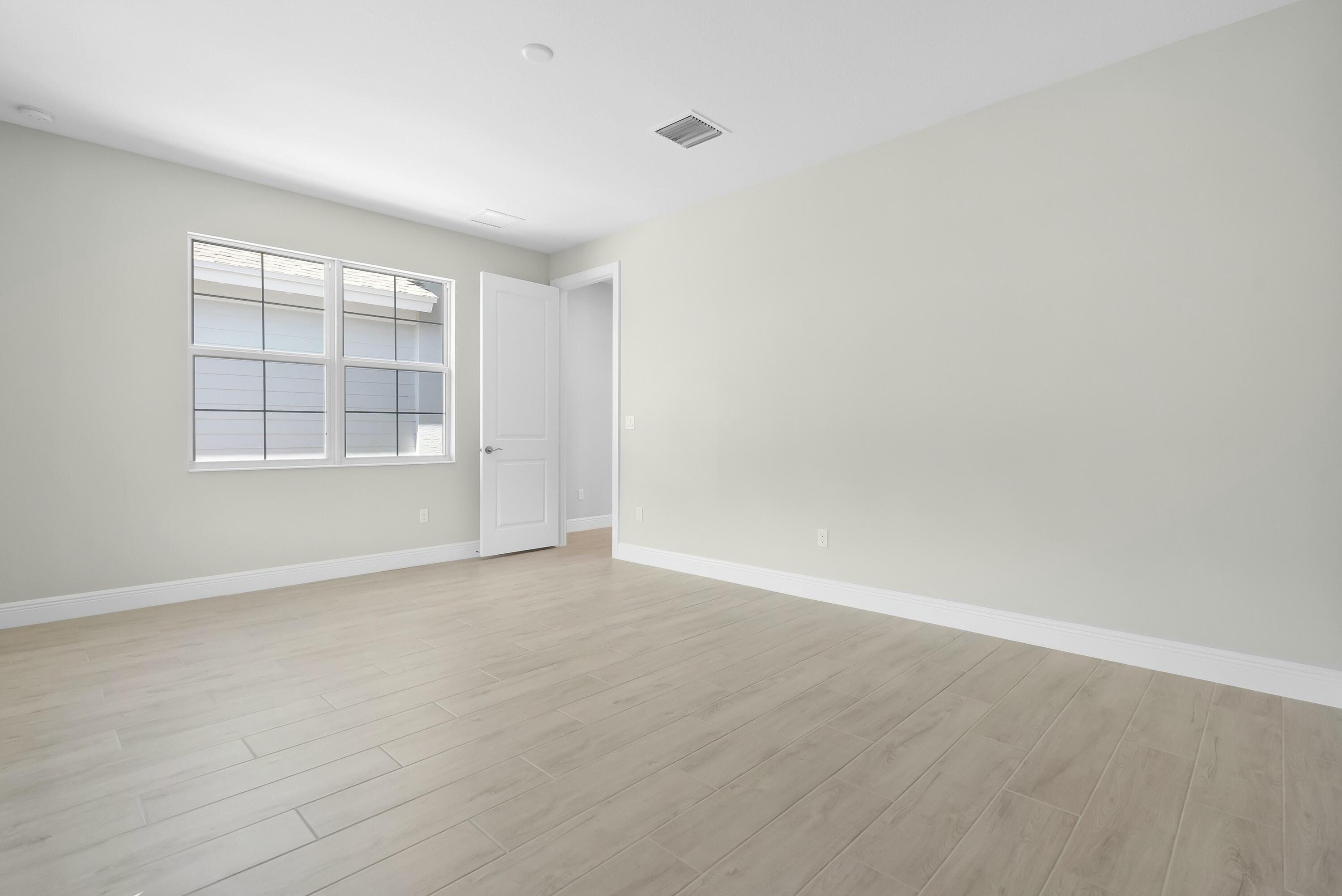 6382 High Pointe Circle Vero Beach, FL 32967 - Photo 11 of 55 wooden floor in an empty room with a window