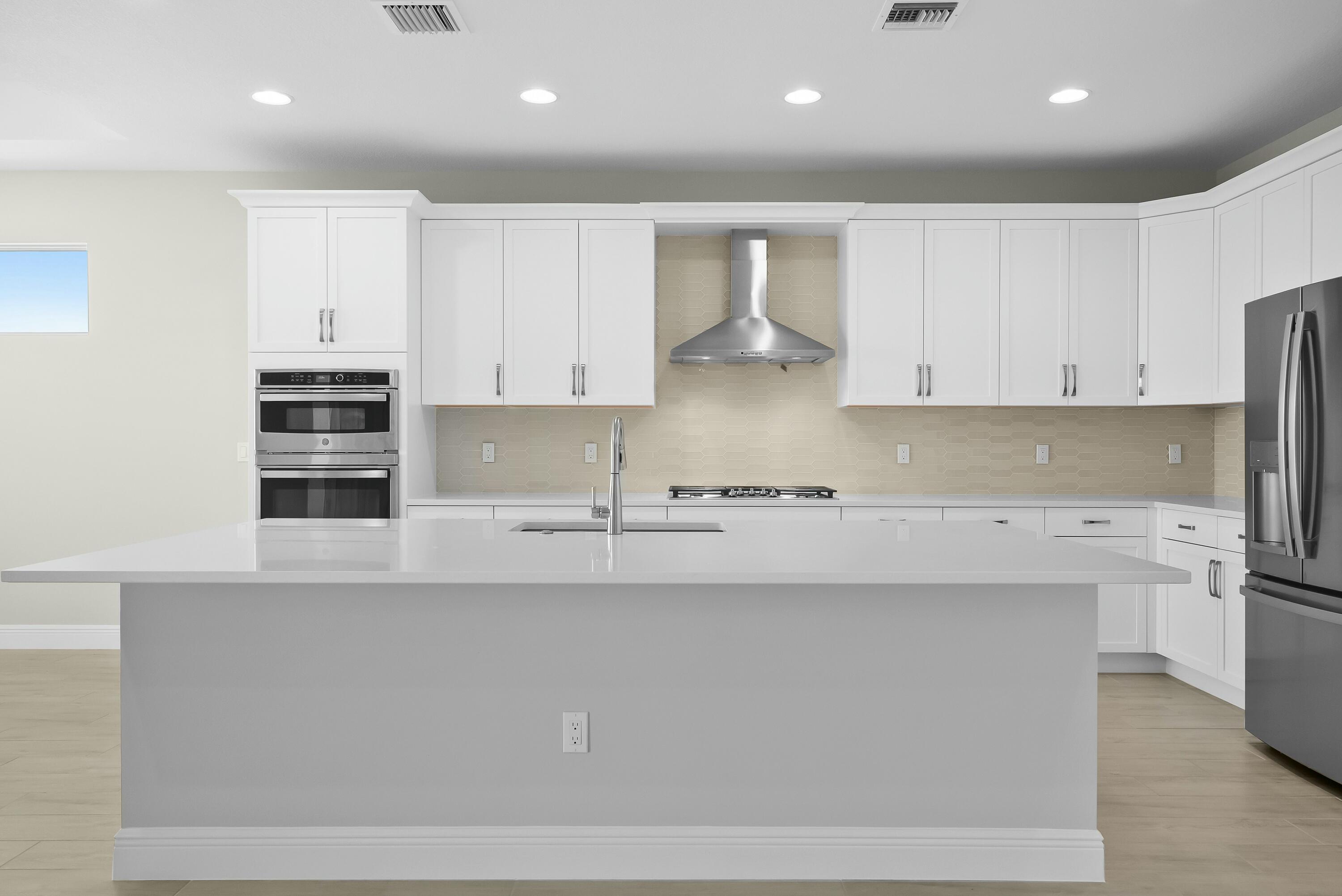 6382 High Pointe Circle Vero Beach, FL 32967 - Photo 18 of 55 a kitchen with stainless steel appliances granite countertop a sink a stove and a refrigerator