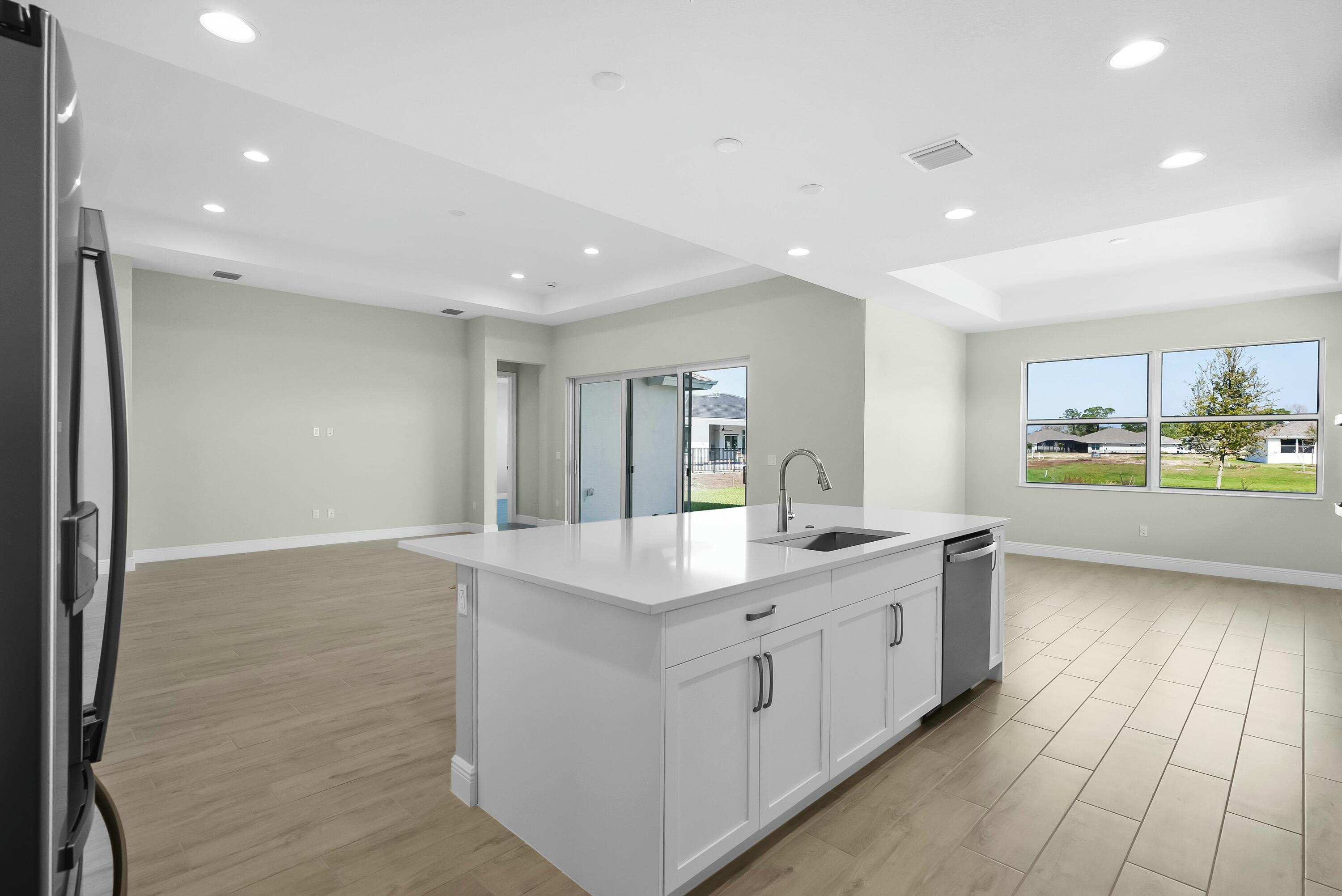 6382 High Pointe Circle Vero Beach, FL 32967 - Photo 26 of 55 a kitchen with stainless steel appliances granite countertop a sink and cabinets