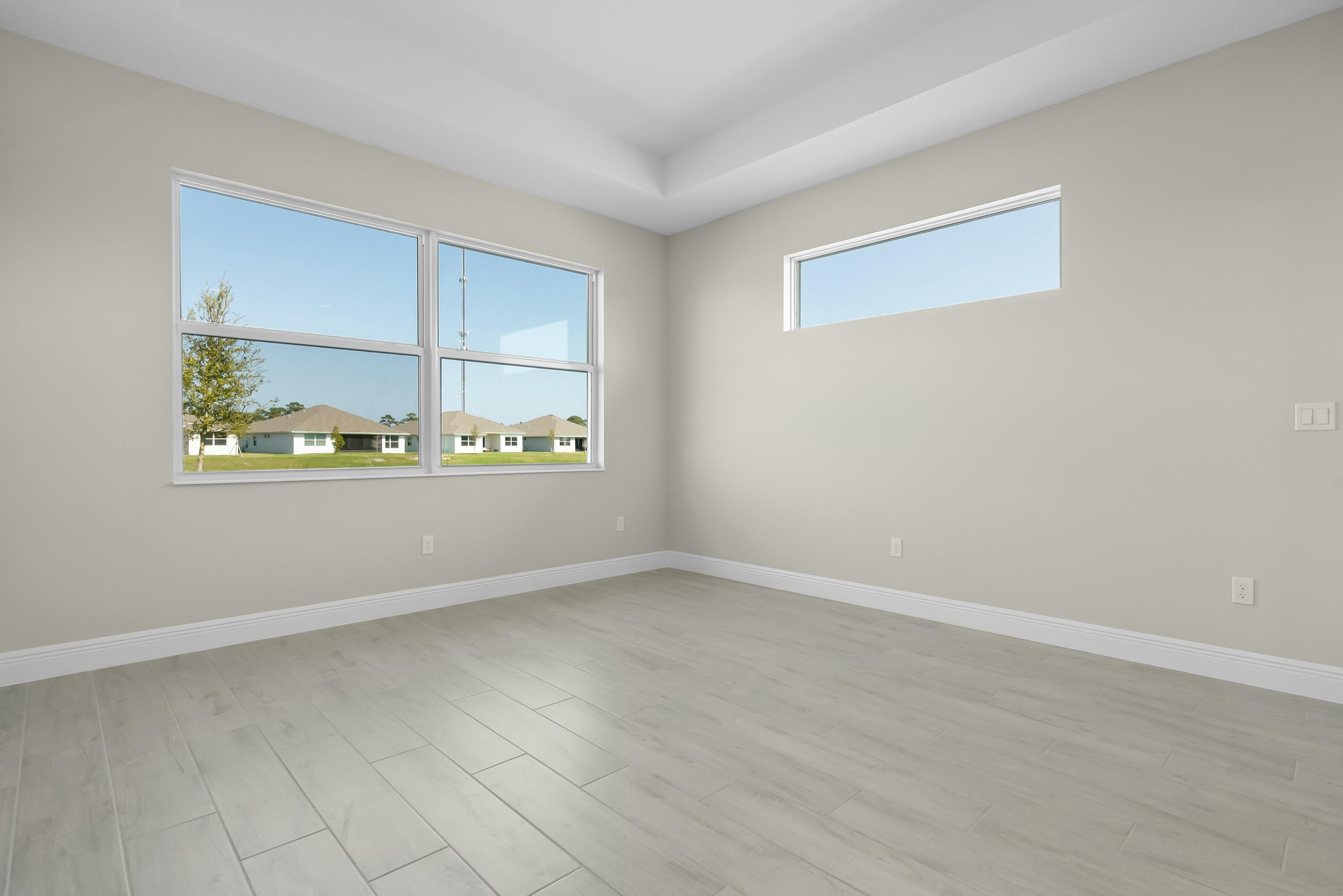 6382 High Pointe Circle Vero Beach, FL 32967 - Photo 27 of 55 an empty room with wooden floor and windows
