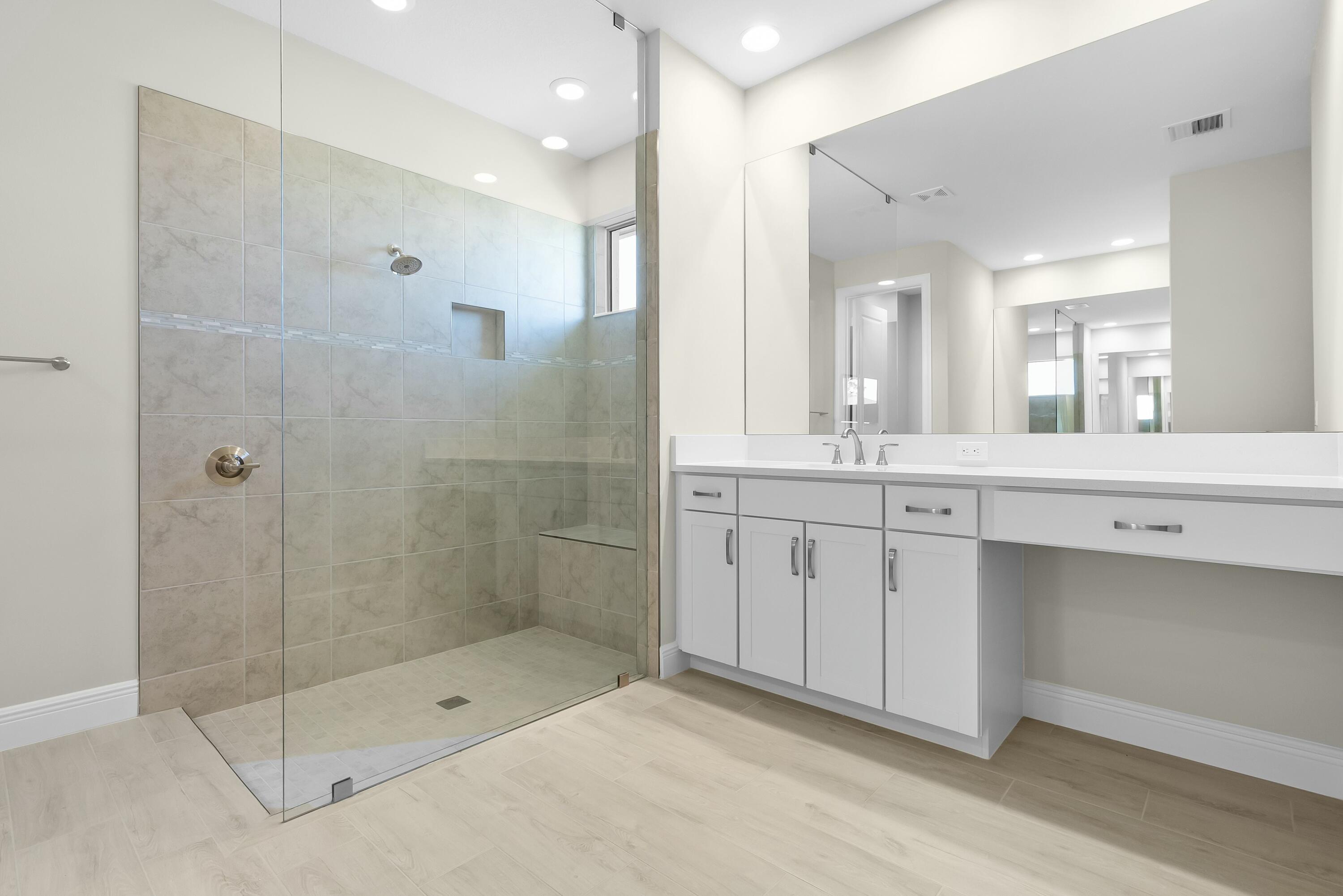 6382 High Pointe Circle Vero Beach, FL 32967 - Photo 33 of 55 a bathroom with a shower sink and mirror