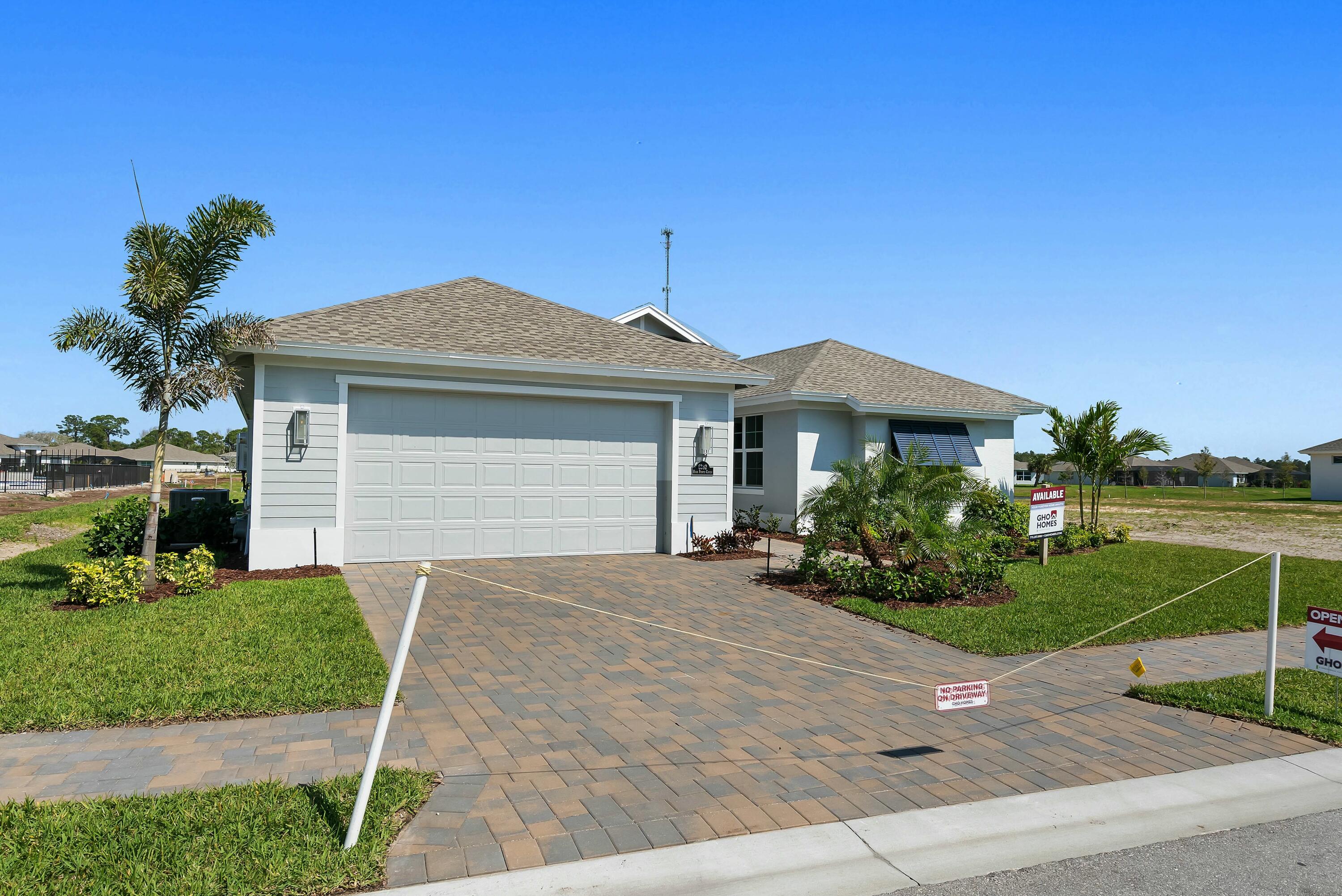 6382 High Pointe Circle Vero Beach, FL 32967 - Photo 42 of 55 a front view of a house with a yard and potted plants