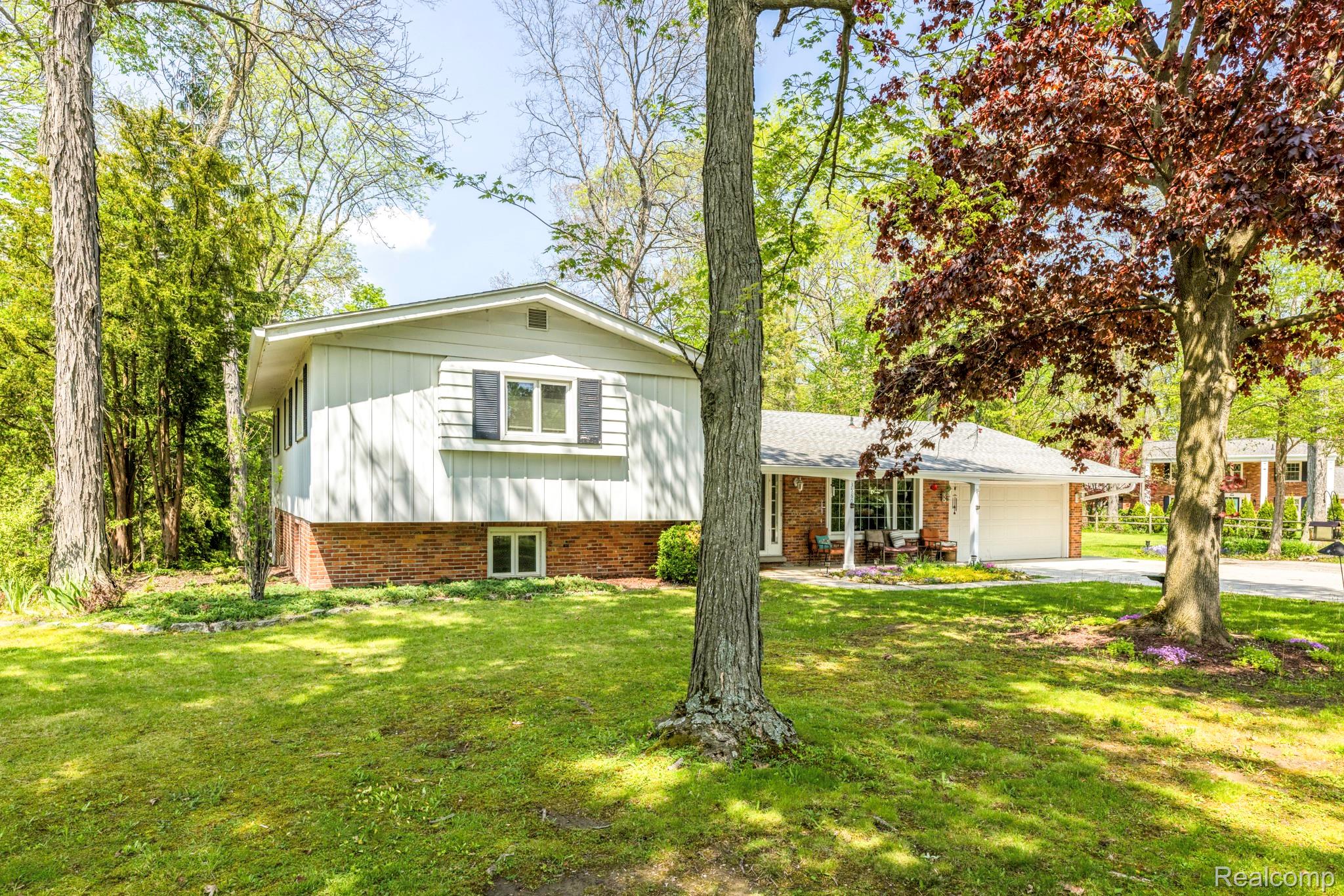 3560 North Road North Street, MI 48049 - Photo 1 of 53 Tri-level home featuring a front lawn, a garage, brick siding, and concrete driveway