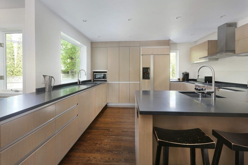 9 Avondale Road Newton, MA 02459 - Photo 2 of 23 a kitchen with kitchen island a sink table and chairs