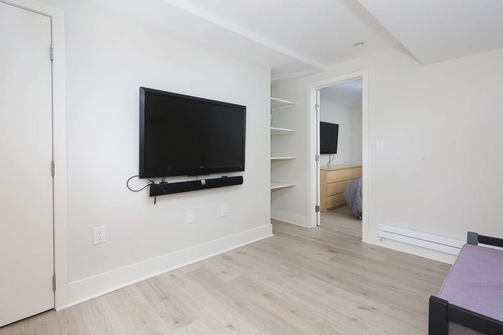 9 Avondale Road Newton, MA 02459 - Photo 21 of 23 a view of a livingroom with wooden floor and a flat screen tv