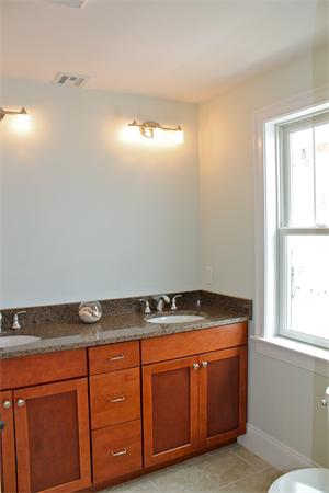 153 Jericho Road, Unit 1 Scituate, MA 02066 - Photo 13 of 26 a room with cabinets and window