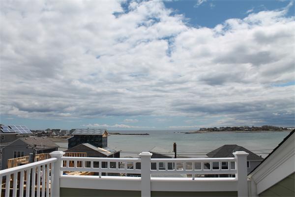 153 Jericho Road, Unit 1 Scituate, MA 02066 - Photo 22 of 26 a view of a lake with a city skyline in the background
