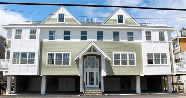 153 Jericho Road, Unit 1 Scituate, MA 02066 - Photo 3 of 26 a view of a brick house with many windows