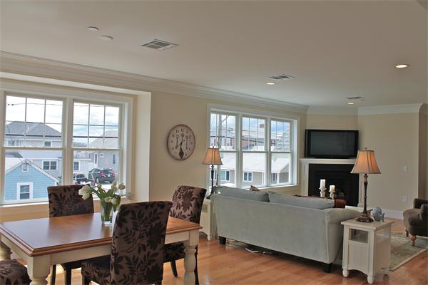 153 Jericho Road, Unit 1 Scituate, MA 02066 - Photo 6 of 26 a living room with furniture a flat screen tv and a large window