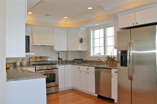 153 Jericho Road, Unit 1 Scituate, MA 02066 - Photo 7 of 26 a kitchen with white cabinets stainless steel appliances and a window
