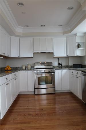 153 Jericho Road, Unit 1 Scituate, MA 02066 - Photo 9 of 26 a kitchen with granite countertop a white cabinets and white appliances