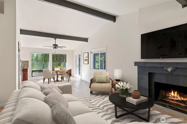 a living room with furniture a fireplace and a flat screen tv