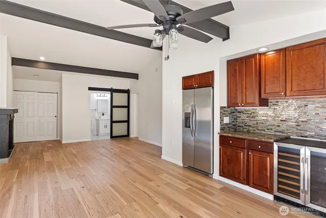 a kitchen with stainless steel appliances granite countertop a refrigerator and a sink