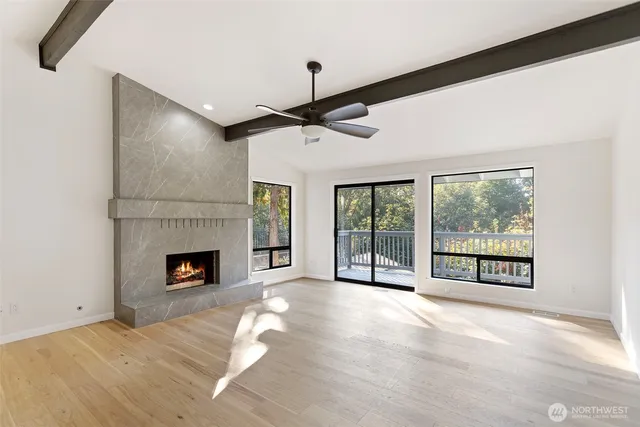 a view of an empty room with a fireplace and a large window