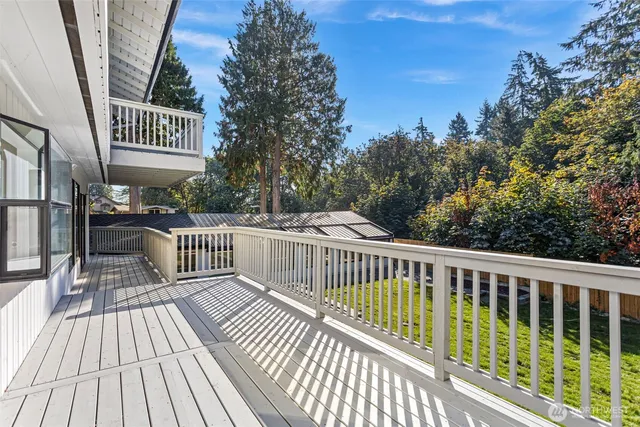 a view of a roof deck with wooden floor and fence