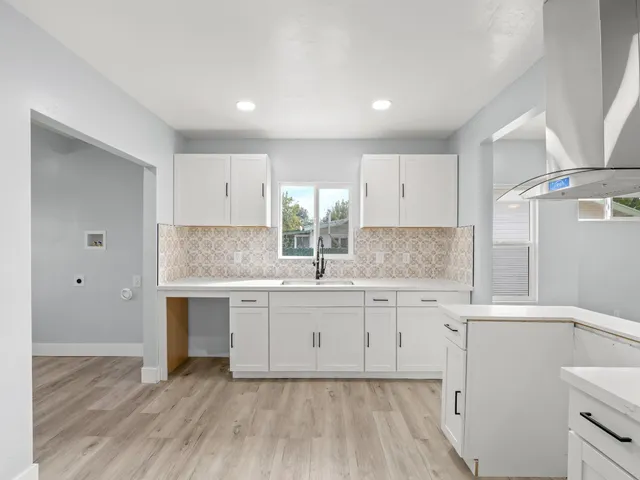 a kitchen with a sink cabinets and window
