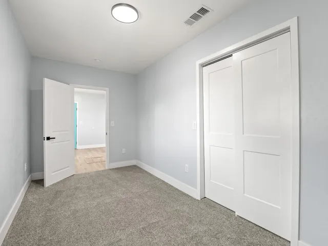 an empty room with closet area