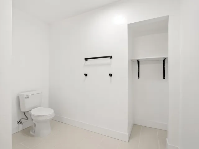 a white toilet sitting next to a white sink