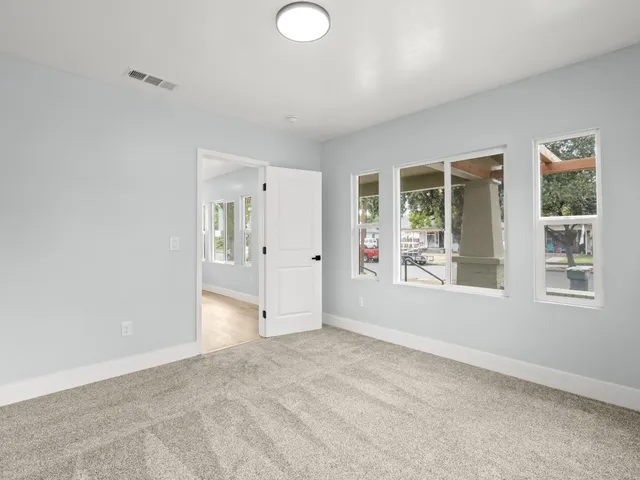 an empty room with windows and entrance