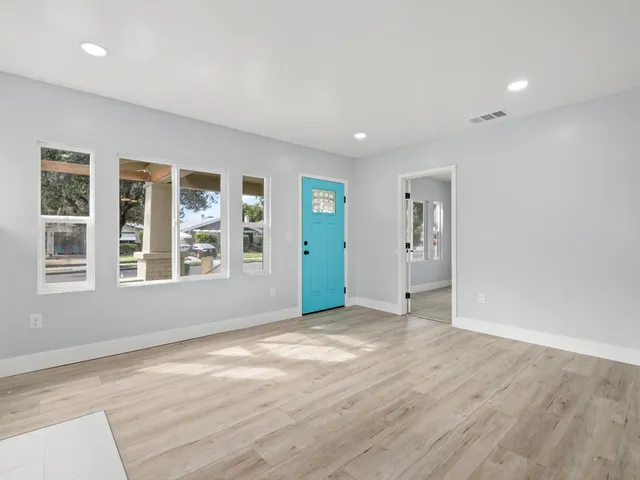 wooden floor in an empty room with a window