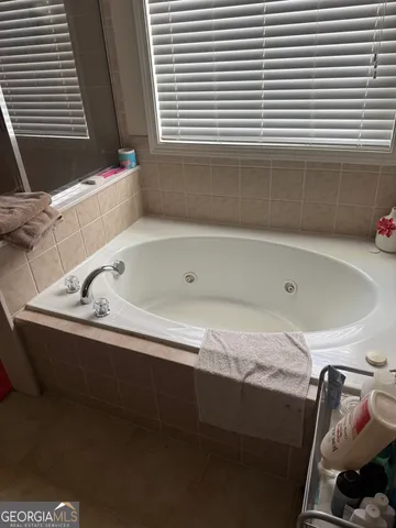 a bathroom with a bathtub and a window