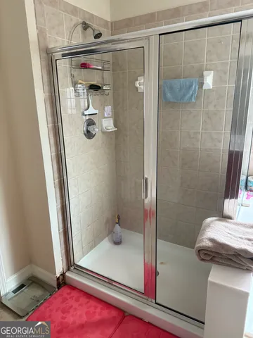 a bathroom with a shower and a sink