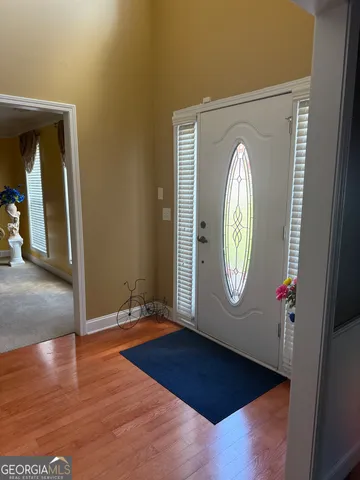 a view of a livingroom with wooden floor and a window
