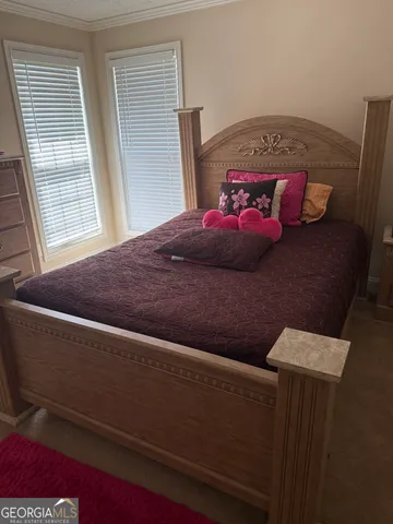 a bedroom with a bed and window