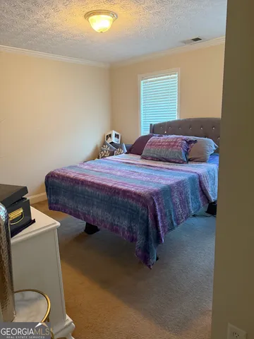 a bedroom with a bed and a cabinets