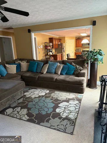 a living room with furniture wooden floor and a large window