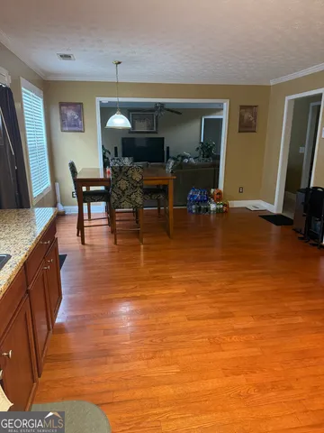 a living room filled with furniture and a flat screen tv