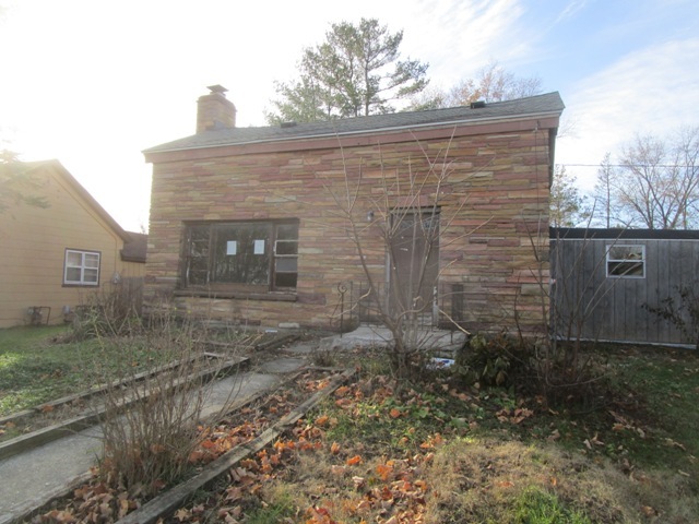 a view of a brick house with a yard
