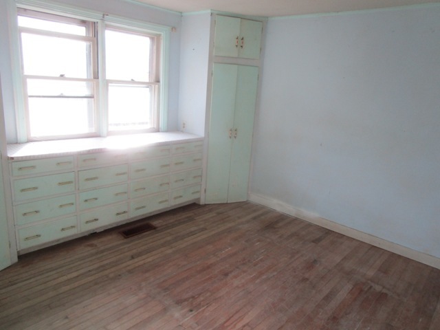 4405 Greenwood Road Woodstock, IL 60098 - Photo 4 of 10 an empty room with wooden floor and windows
